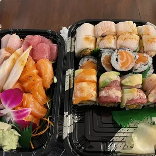 two trays of sushi on a table