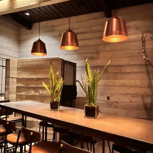 a restaurant with a long table and chairs