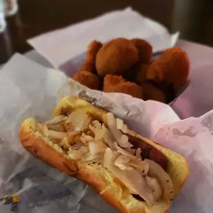 German dog with sauerkraut, grilled onions, and mustard on a split and grilled dog and toasted bun. Mmmm!