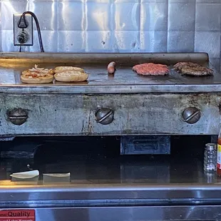 Burgers and dog on the flattop grill.