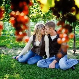 a couple sitting on the grass