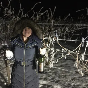a woman holding a bottle of wine