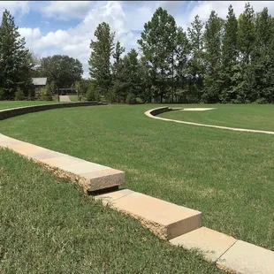 Sitting, outdoor concert area, raised in an area also a great area in which to fly drones.