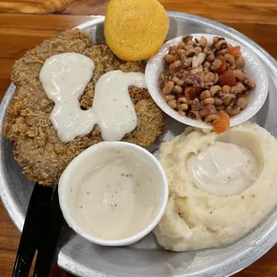 Chicken fried steak with mashed potatoes and black eyed peas and some of the best country gravy I&apos;ve ever had.