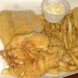 Tilapia and a chicken breast, fries and cole slaw