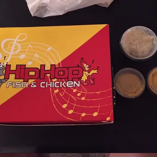 The box, two containers of honey mustard, and coleslaw.