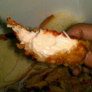 Bit off chicken tender, juicy and meaty