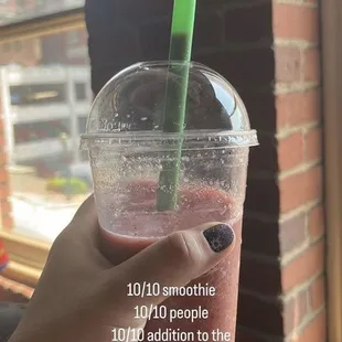 a hand holding a smoothie