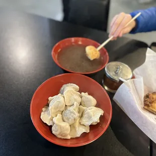 two bowls of dumplings and a bowl of soup
