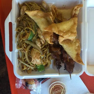 a tray of food with noodles and meat