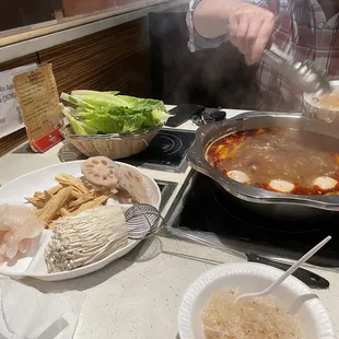 Enoki mushrooms, fish, bean curd, lettuce, fish balls with roe