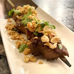 Yakitori lemongrass pork with nuoc Cham, peanuts, and cilantro. Just a hint of heat from the Thai chilies made this a fabulous bite of food.