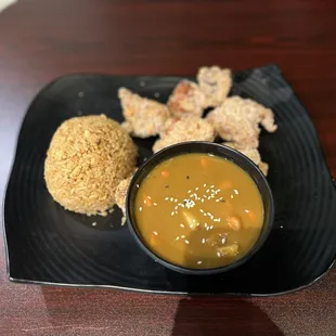 Chicken karage with a side of curry and fried rice