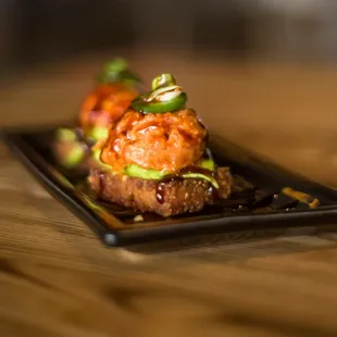 Crispy Rice Spicy Tuna served with a portion of crispy rice, avocados, jalepeno, spicy tuna and sweet sauce on top