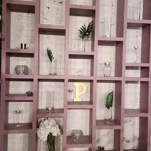 a shelf with vases and flowers