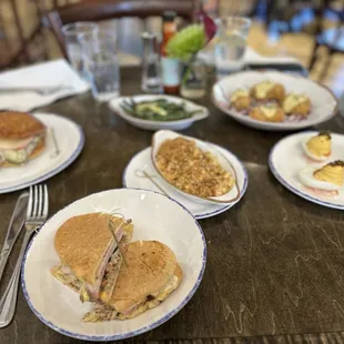 From top left to right: Duck Confit Melt, Cajun Cuban, Shrimp Mac n Cheese, deviled eggs, fried oysters and green beans
