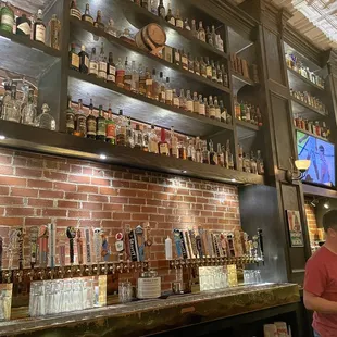 a man standing in front of the bar