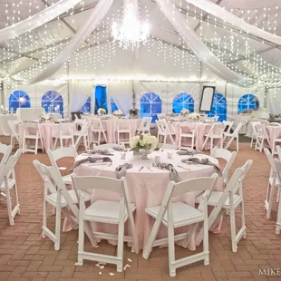 Our permanent marquee tent features brick flooring, drapery, and lighting. Photo by Mike Topham Photography