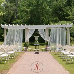 Our eight-pillar Grecian pergola is a popular garden ceremony site.  Photo by Rowlands Photography