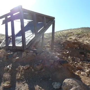 an old wooden structure in the desert