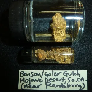 a glass jar containing a gold nuggie