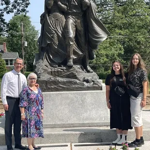 In front of the sculpture with two of the guides.