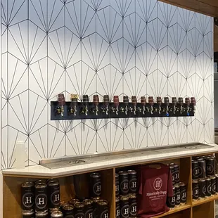 a row of beer taps on a wall