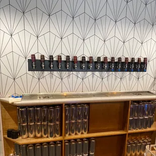 a row of beer glasses on a shelf