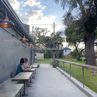 two women sitting at a picnic table