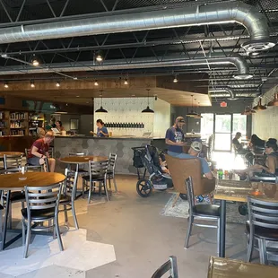 people sitting at tables in a restaurant
