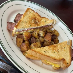 Turkey bacon,egg and cheese sandwich with home fries.