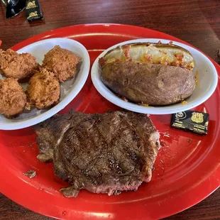 Ribeye, baked potato and hush puppies.
