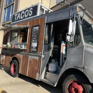 a tacos truck parked on the side of the road