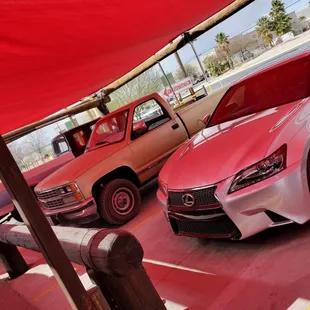 two cars parked under a tent