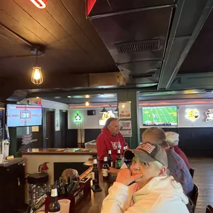a group of people sitting at a bar