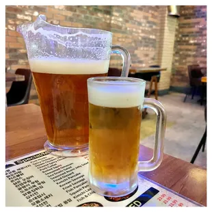 a pitcher and a glass of beer