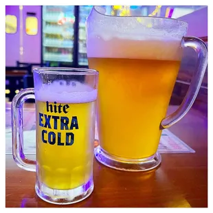 a glass of beer and a mug of beer