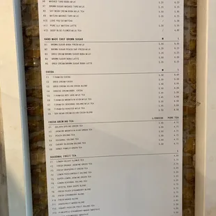 a menu on a brick wall