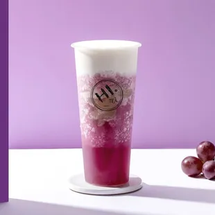 a cup of plum juice and a bunch of plums