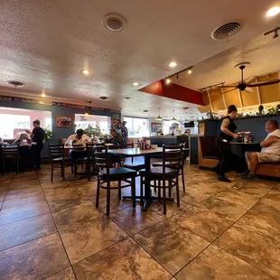 people sitting at tables in a restaurant