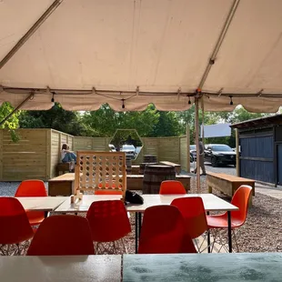 a patio area with tables and chairs