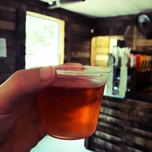 a hand holding a cup of tea