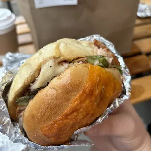 a hand holding a sandwich