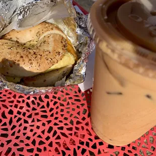 a sandwich and iced coffee on a table