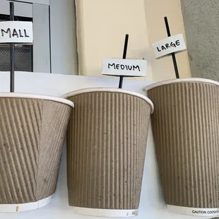 three disposable cups of coffee