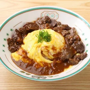 a bowl of stew and mashed potatoes