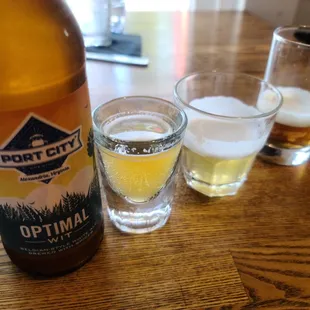 a bottle of beer and two glasses of beer