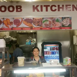 Hmoob Kitchen and its classy proprietor. Homemade tofu can be seen on the counter.