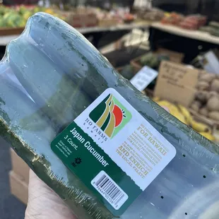 a hand holding a bottle of fresh produce