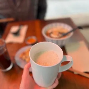 a person holding a cup of coffee